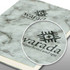 A marble-patterned soft cover notebook in shades of grey, featuring a logo on the front.