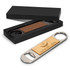 A drink bottle opener with a wooden top and metal body, presented in a black gift box. It has a brand logo.