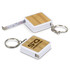 A bamboo tape measure key ring with a white casing and a silver key ring attachment. Features a measuring tape inside.