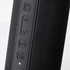 A black Bluetooth speaker featuring textured material and control buttons on the side. Contains a branding logo.