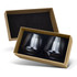 A gift box containing two clear, dark-coloured whiskey glasses with a sleek, modern design.