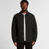A man wearing a black quilted jacket with a button-up front and a collared neck. The jacket has a logo.