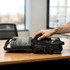 A black laptop bag with various compartments, open to reveal an organiser and space for accessories.