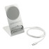 A silver wireless charging stand with a circular charging pad and a white USB-C cable. It features a logo on the base.