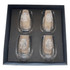 A set of four clear glass wine glasses with etched white text, presented in a black gift box.