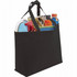 A black non-woven tote bag filled with a drink bottle, magazines, and various household items. The bag has two handles and a simple design.