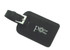 A black leather luggage tag featuring a silver buckle and a floral logo.