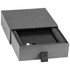 A black box containing a wireless charger with a sleek design and cushioning inside. Includes branding.