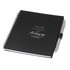 A black spiral-bound journal with a silver pen attached. The journal features motivational text and has a logo.