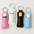 A collection of four neoprene keychains in pink, white, black, and blue, each holding a small tube.