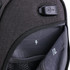 A close-up of a grey wheeled underseat luggage, featuring an interior pocket with a logo and charging port.