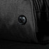 A black wash bag featuring a textured fabric and a logo button. Ideal for toiletries and accessories.
