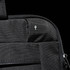 A black laptop sleeve featuring a small logo, showcasing a textured fabric and zip closure.