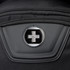 A close-up of a black backpack featuring a round logo on a zippered pocket.