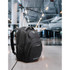 A black Swissdigital Stealth Neptune backpack with pockets and a logo, positioned in an airport setting.