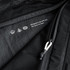 A black packing cube with a mesh panel and zip closure, featuring a subtle logo and design details.