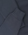 A close-up of a navy oversized hoodie featuring ribbed cuffs and soft fleece material. It includes a logo.