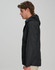 A black unisex waterproof jacket with a hood and a side view of a model wearing it. Features a logo on the jacket.