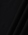 A close-up of black ultrafine cotton pique fabric, textured with a smooth finish. It features subtle folds.