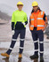 A woman in a high-vis yellow and navy hoodie and a man in an orange vest wear navy pants with reflective tapes.