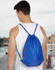 A blue swim backpack with drawstring closure, worn on the back of a person, showing a scenic waterfront.
