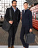 A man in a black jacket holds a black laptop bag, while a woman in a dark blue jacket carries a grey bag.