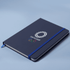 A navy A5 notebook with an elastic band closure and an Olympic-themed logo on the cover.
