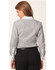 A long-sleeve shirt in grey tic stripe pattern with white collar and cuffs, featuring a logo on the back.