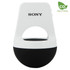 A white and black wireless speaker with a loop handle and logo branding. Compact and modern design.