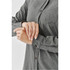 A grey button-up shirt with long sleeves and a pocket, showcasing the cuff detail. Features a logo on the fabric.