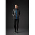A woman wearing a black rain jacket with blue accents, featuring a zip front and a pocket.