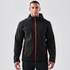 A black softshell hoody with red accents, featuring a zip front, zip pockets, and a hood. Includes branding.