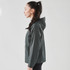 A women's dark green Pacifica wind jacket with a hood, featuring a sleek design and a side view.