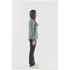 A green women's jacket is displayed on a model standing sideways against a plain background.