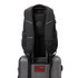 A black Swissdigital Neptune Backpack displaying padded straps and mesh detailing, designed for easy transport on luggage.