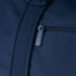A close-up of a navy blue duffel bag featuring a zippered pocket and textured fabric. It has a logo present.