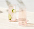 A set of two highball glasses in soft pink, featuring a modern design and minimalistic style.