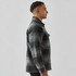 A men's plaid jacket in black and grey with a Sherpa lining, featuring a front pocket and a classic collar.