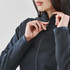 A women's Appaloosa knit jacket in dark grey, featuring a zippered front and a close-up of the collar area.