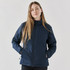 A woman wearing a navy blue thermal jacket with a zippered front and side pockets, featuring a logo.