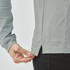 A light grey long sleeve polo shirt, featuring a side slit detail and a logo on the hem.