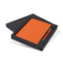 An orange notebook and pen set presented in a black gift box. The box is partially open to reveal the contents.