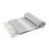 A rolled grey blanket with white stripes and fringed edges, featuring a soft, textured fabric.