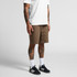 Canvas shorts in a brown shade, featuring a relaxed fit and cargo-style pockets, paired with a plain white T-shirt and black sneakers.