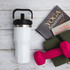 A drink bottle with a sleek white body and stainless steel accents, featuring a black lid and handle.