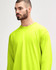 A bright yellow long sleeve t-shirt with a relaxed fit. It features a logo on the front.