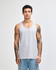 A light grey unisex fine jersey tank top is displayed on a model, featuring a simple design and a relaxed fit.
