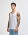 A unisex fine jersey tank in grey, featuring a logo, displayed by a model wearing casual jeans.