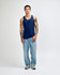 A model wearing a navy blue unisex fine jersey tank top paired with black cargo pants and sneakers.