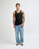 A black unisex fine jersey tank top worn with baggy black pants and sneakers, featuring a visible logo.